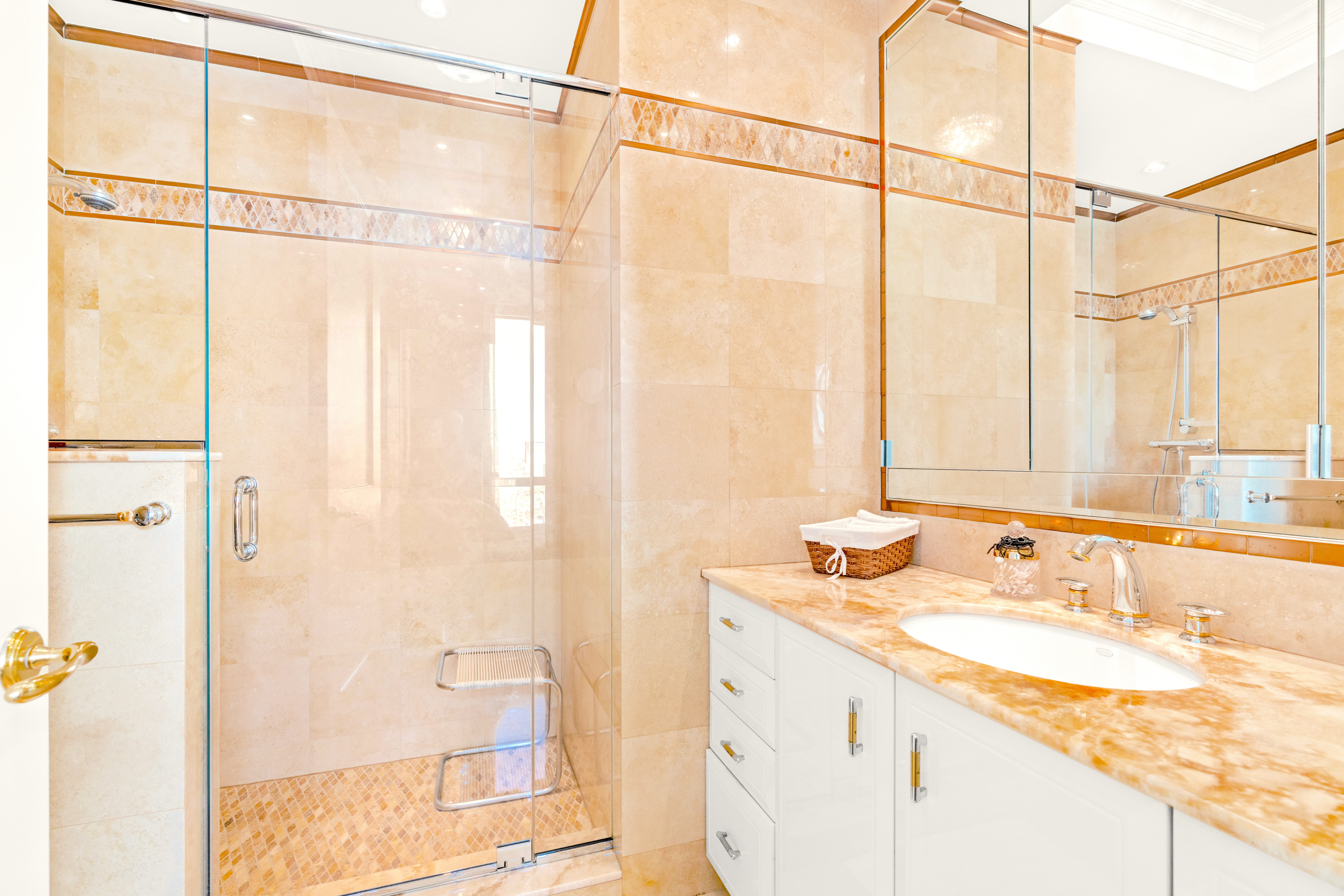 1965 Broadway, Unit 26EF Manhattan, NY 10023 - Photo 22 of 32 a bathroom with a granite countertop sink and a mirror