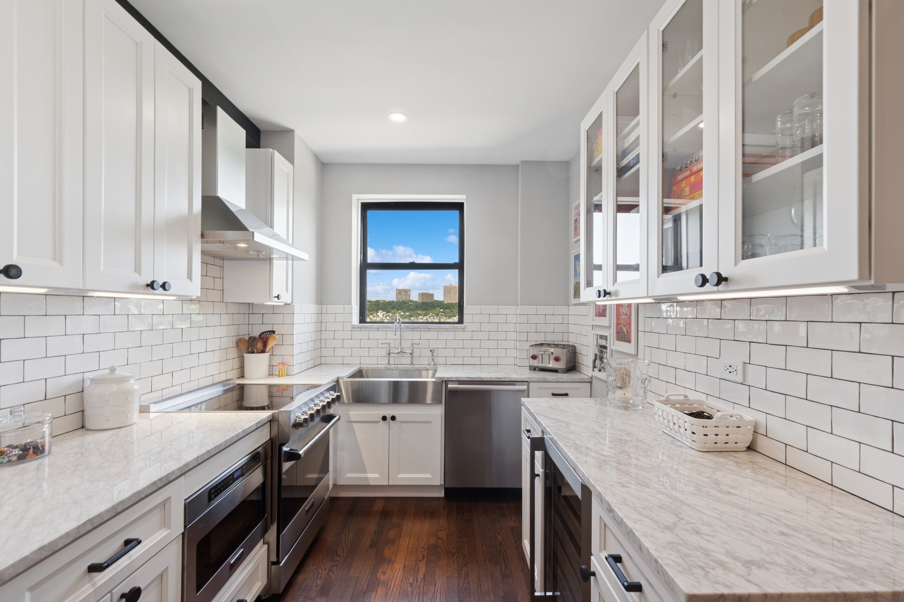 159-34 Riverside Drive West, Unit 5A Manhattan, NY 10032 - Photo 5 of 29 a kitchen with a sink a stove and cabinets