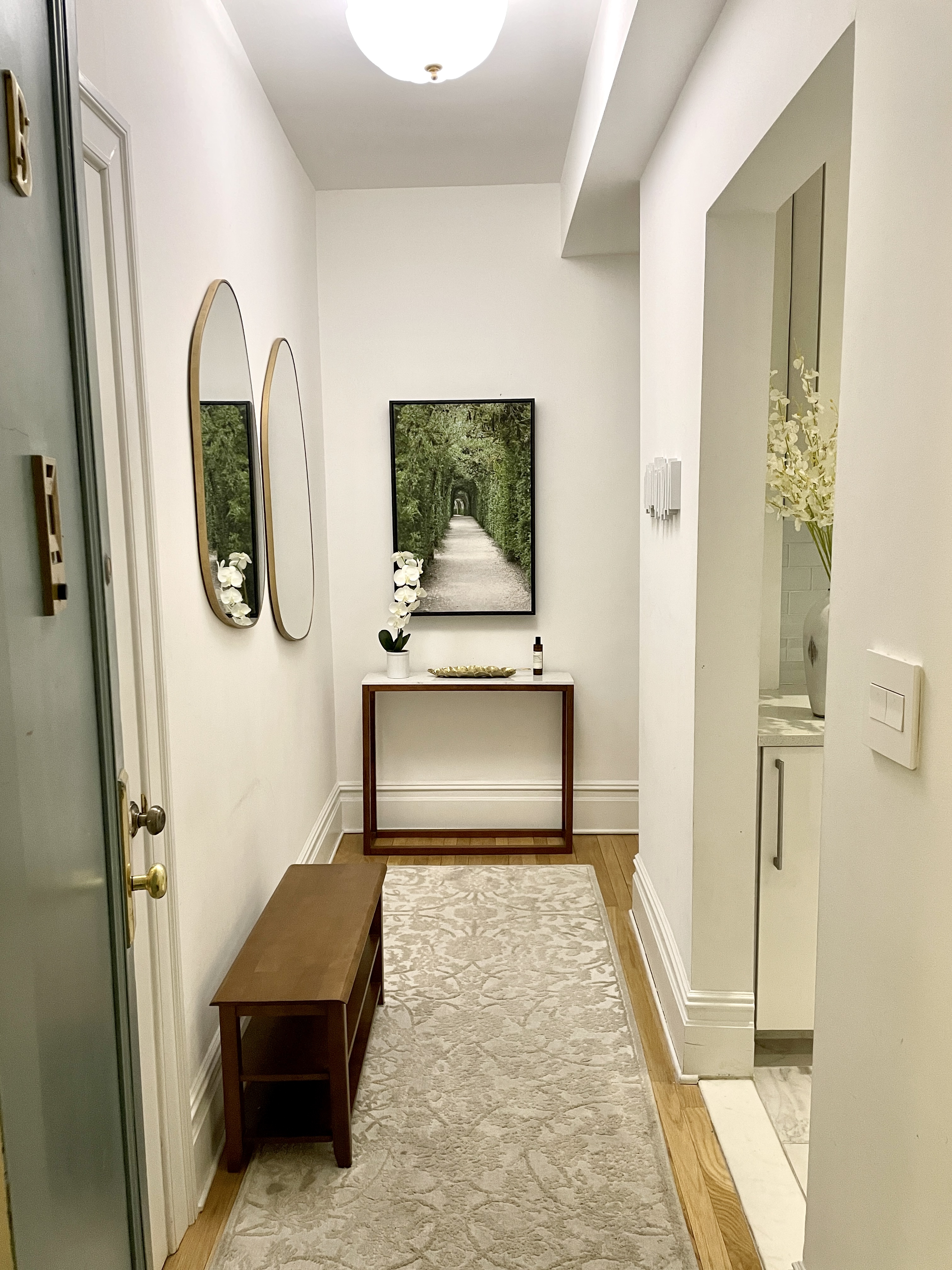 203 West 90th Street, Unit 6B Manhattan, NY 10024 - Photo 4 of 22 a view of a hallway with wooden floor windows and a mirror