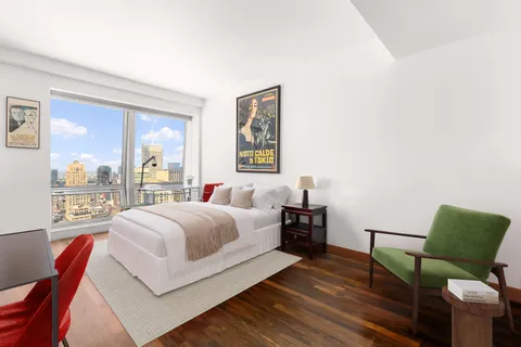 a bedroom with a bed and window