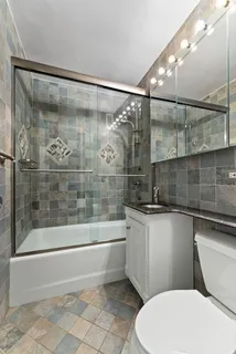 a bathroom with a sink mirror toilet and bathtub