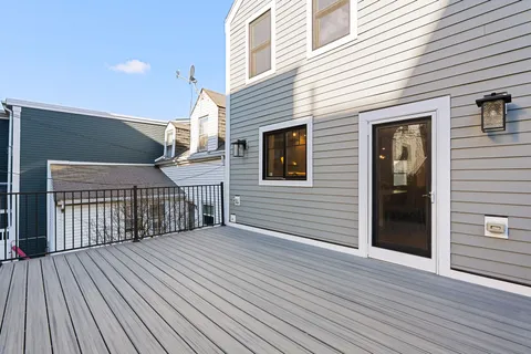 a view of a house with wooden deck