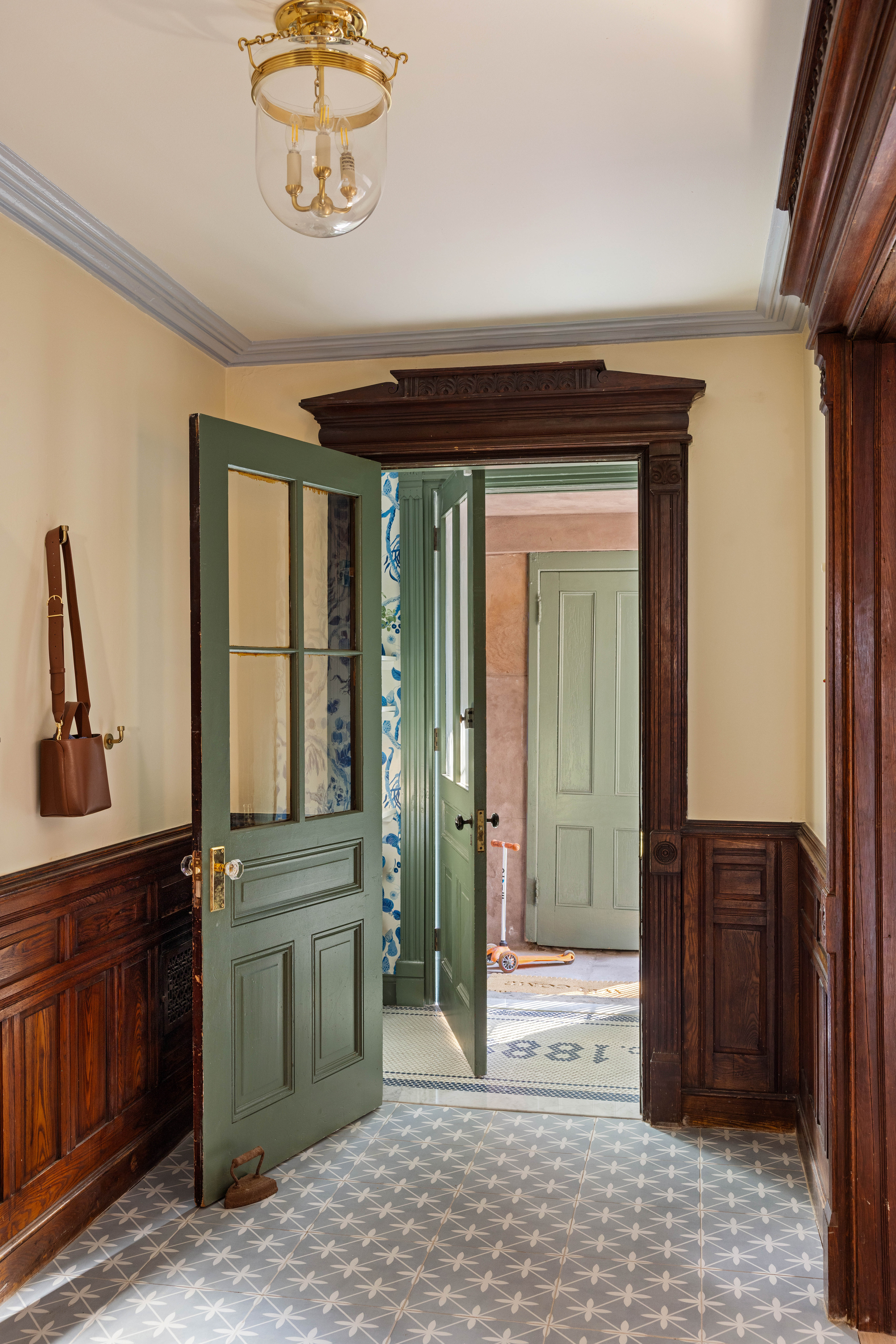 787 Carroll Street Brooklyn, NY 11215 - Photo 28 of 32 a view of a hallway with windows and chandelier