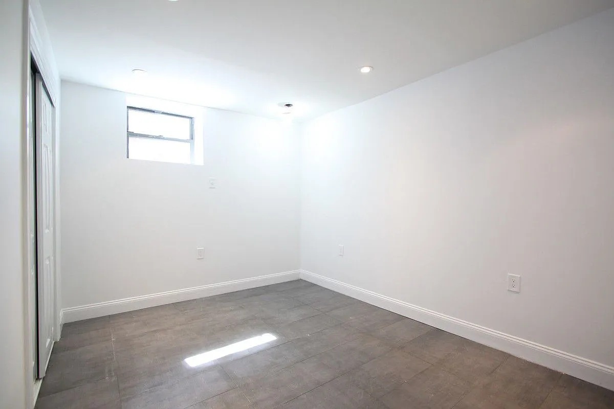 186 Howard Avenue Brooklyn, NY 11233 - Photo 12 of 14 an empty room with a window