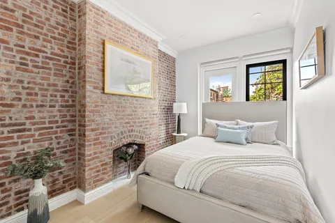 a bedroom with a bed and a wall painting