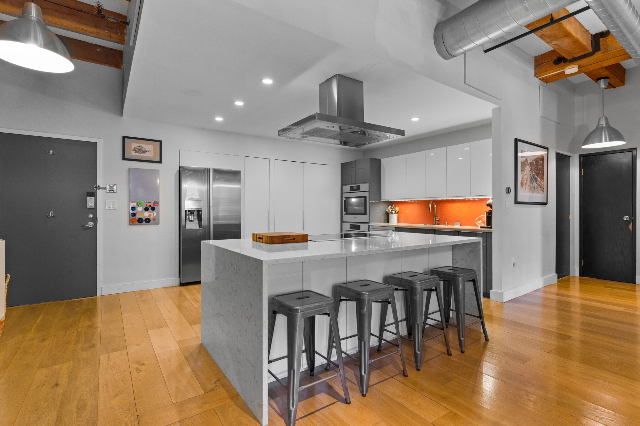 33 Sleeper Street, Unit 307 Boston, MA 02210 - Photo 6 of 15 a kitchen with stainless steel appliances kitchen island a refrigerator and a stove