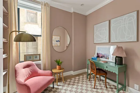a reading room with furniture a rug and a window