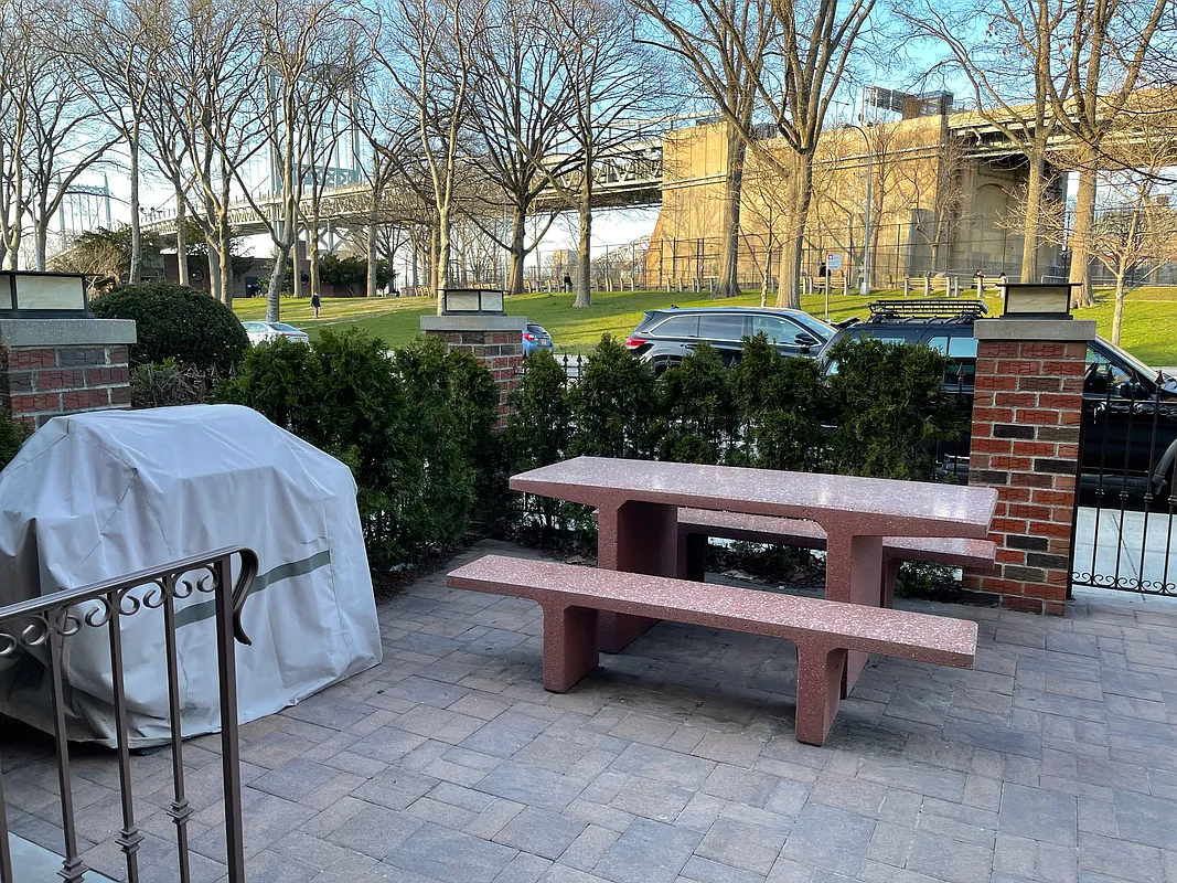 a view of a chairs and fire pit in the back yard