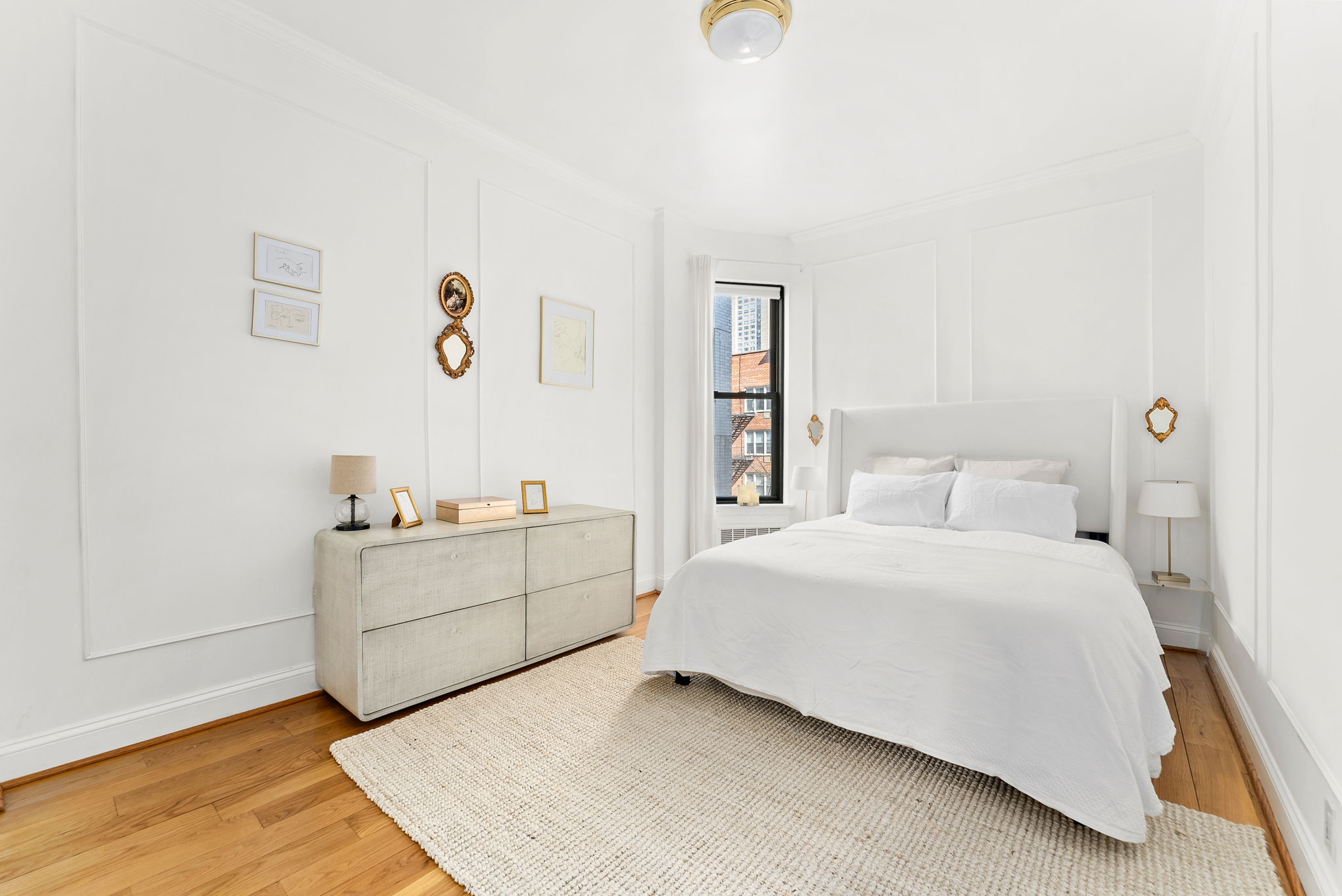 512 East 83rd Street, Unit D4 Manhattan, NY 10028 - Photo 11 of 21 a room with a bed and a dresser