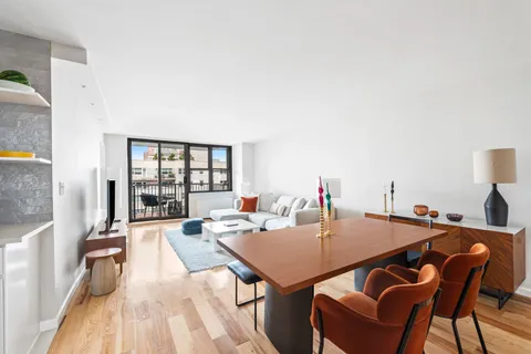 a view of a dining room with furniture and window
