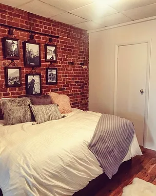344 East 61st Street, Unit 12 Manhattan, NY 10065 - Photo 5 of 10 a bedroom with a bed and a book shelf