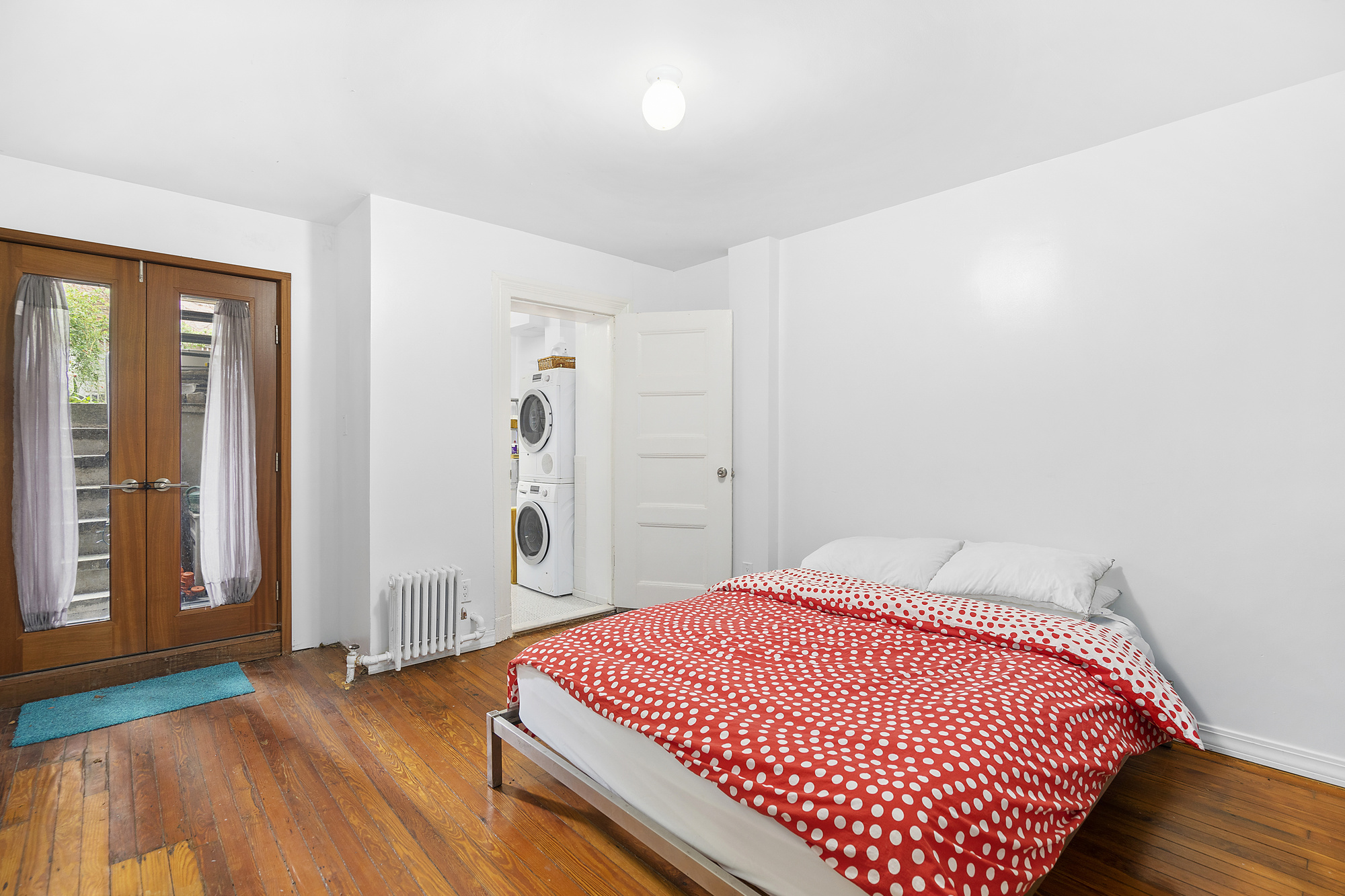394 Lafayette Avenue, Unit 1 Brooklyn, NY 11238 - Photo 3 of 4 a bedroom with a bed and wooden floor