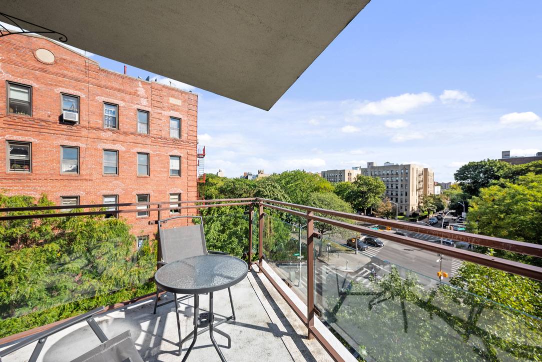 702 Ocean Parkway, Unit 5A Brooklyn, NY 11230 - Photo 5 of 9 a balcony with table and chairs