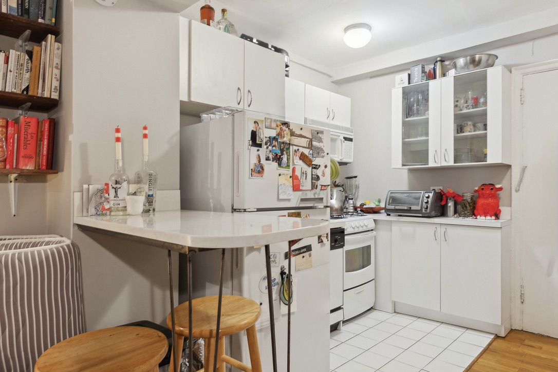 235 West 102nd Street, Unit 8A Manhattan, NY 10025 - Photo 2 of 5 a kitchen with a sink appliances and cabinets