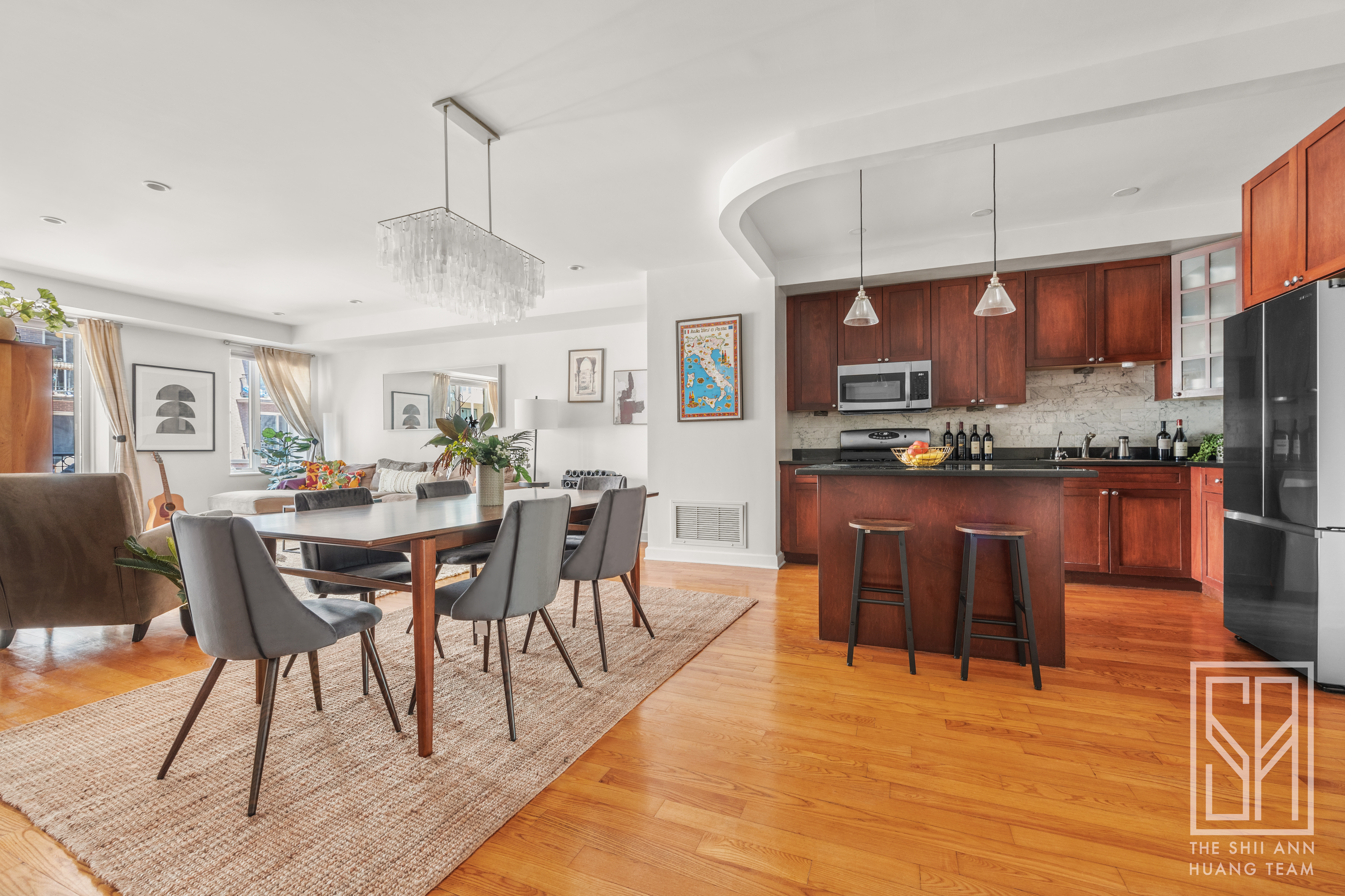 305 3rd Street, Unit 2H Brooklyn, NY 11215 - Photo 3 of 14 a open kitchen with stainless steel appliances kitchen island granite countertop a dining table chairs and a refrigerator