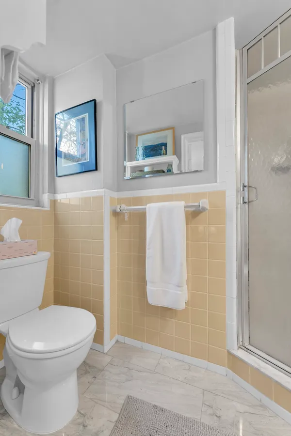 a bathroom with a toilet and a shower