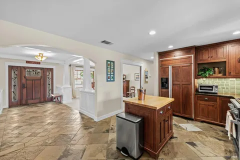 a spacious bathroom with a double vanity sink toilet mirror and shower