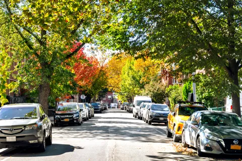 a view of a parking space with cars parked