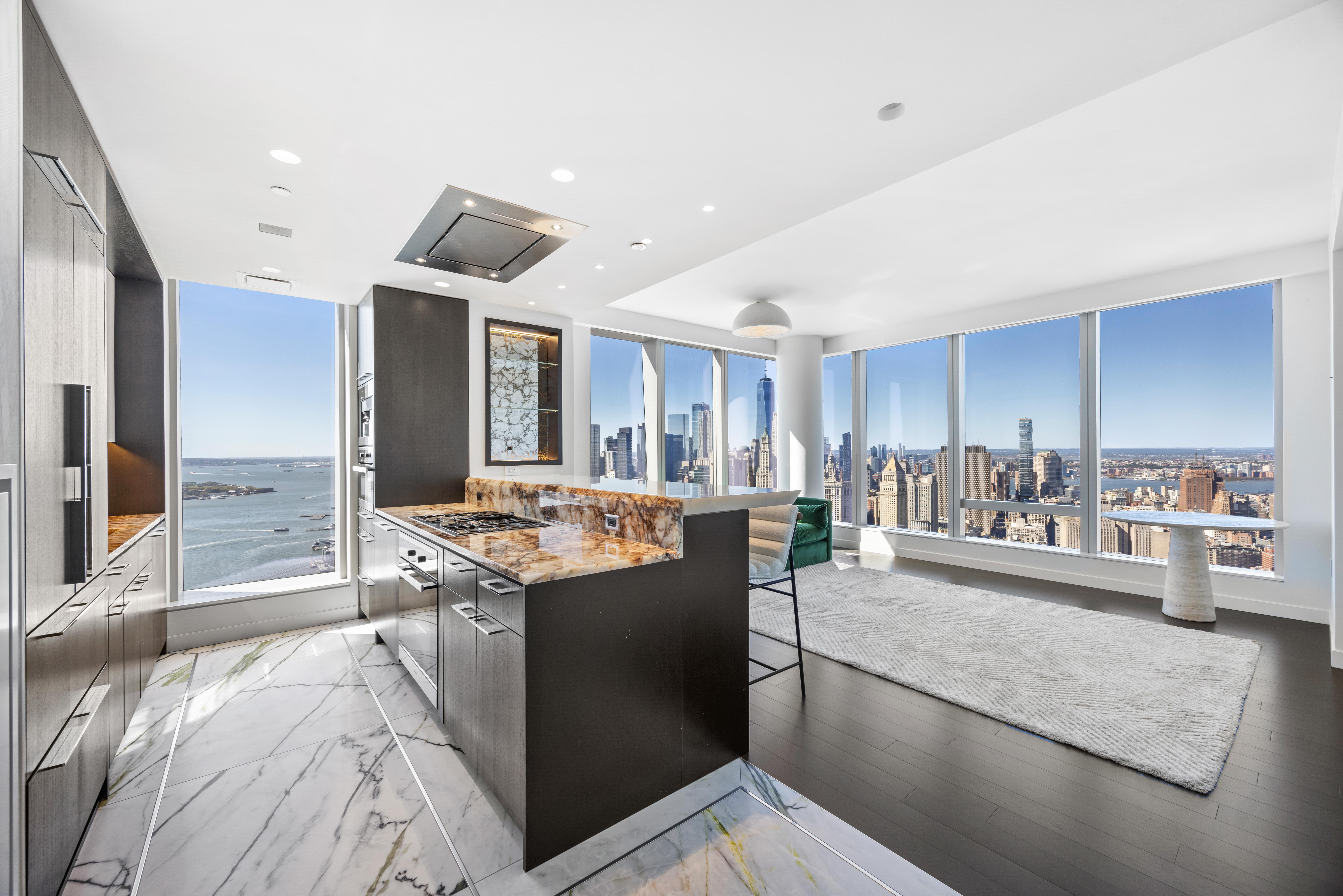252 South Street, Unit 61A Manhattan, NY 10002 - Photo 1 of 29 a kitchen with stainless steel appliances granite countertop a sink and cabinets