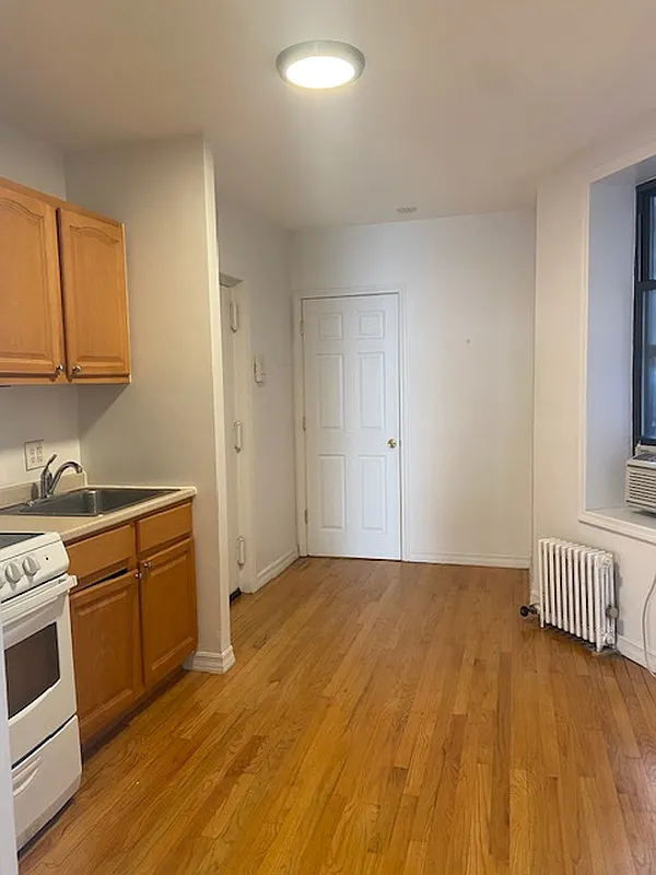 178 Ludlow Street, Unit 3A Manhattan, NY 10002 - Photo 5 of 7 a kitchen with a sink a stove and cabinets