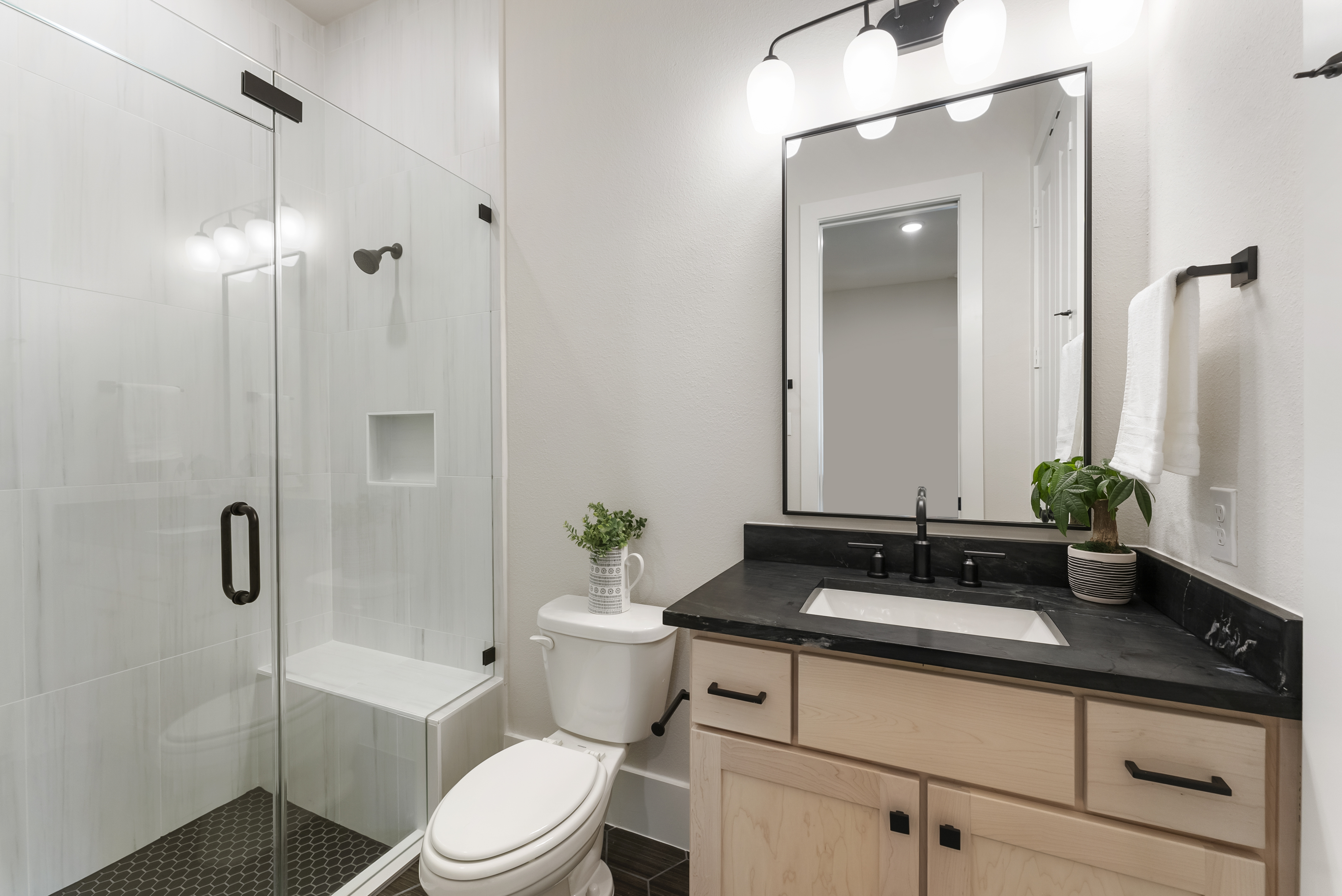 2118 Bennet Court Conroe, TX 77384 - Photo 49 of 70 a bathroom with a sink a toilet a mirror and shower