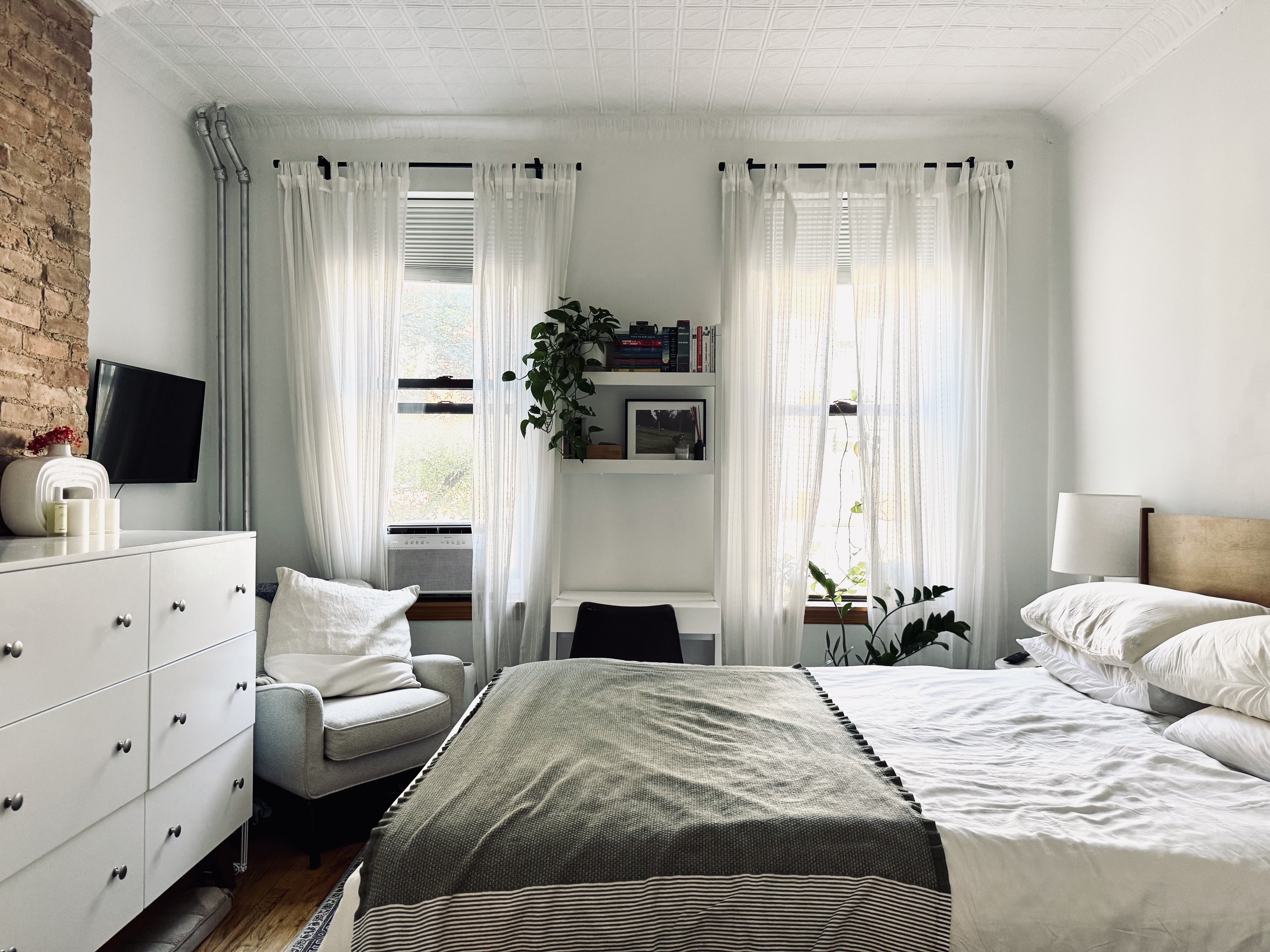 a bedroom with a bed and a flat screen tv