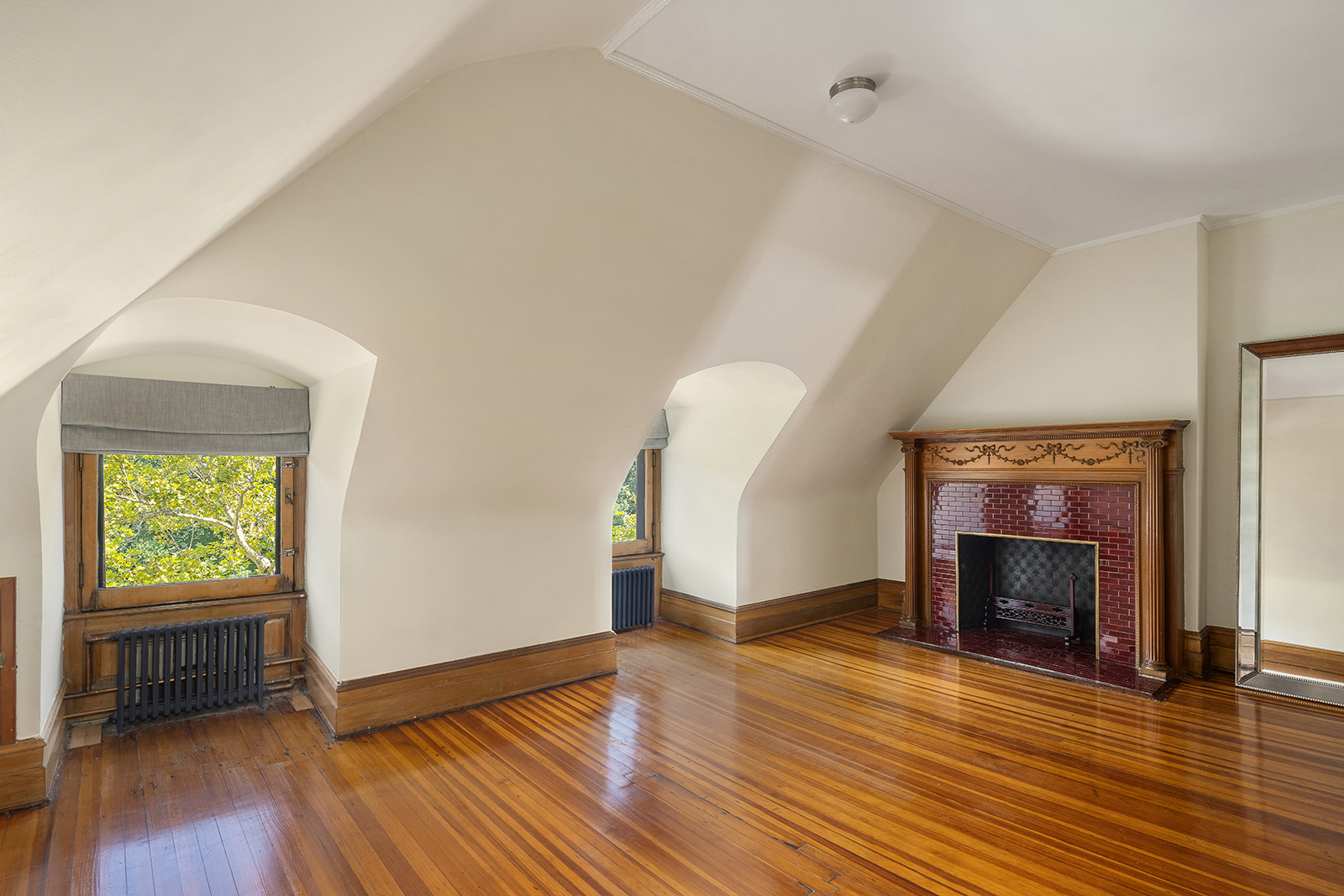 18 Prospect Park West Brooklyn, NY 11215 - Photo 31 of 40 an empty room with wooden floor a fireplace and windows