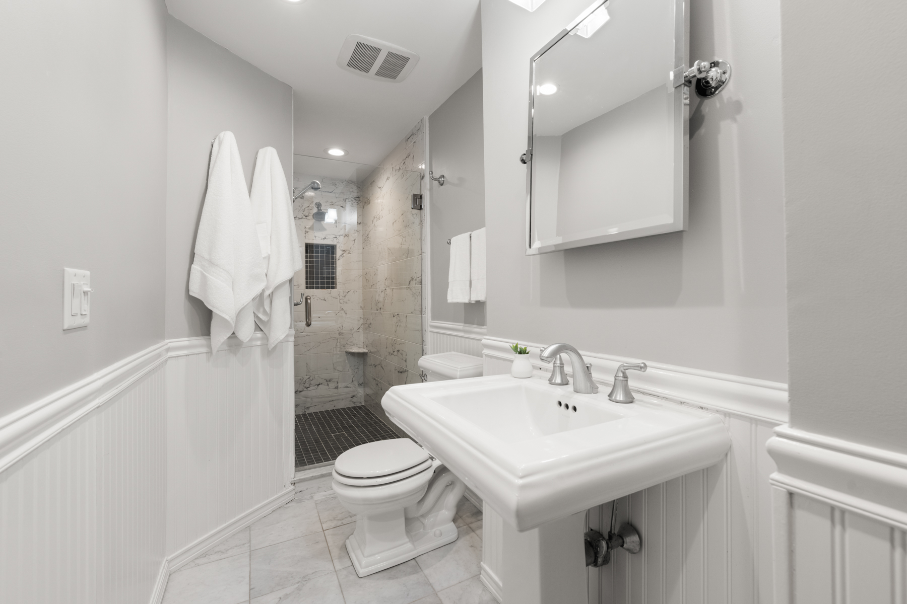 63 West Cedar Street, Unit 3 Boston, MA 02114 - Photo 11 of 17 a bathroom with a sink a toilet and a mirror