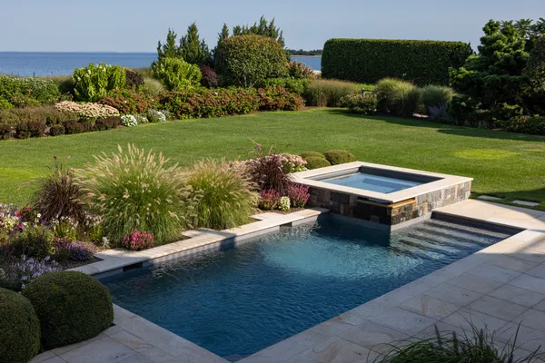 a view of a backyard with plants garden and outdoor seating