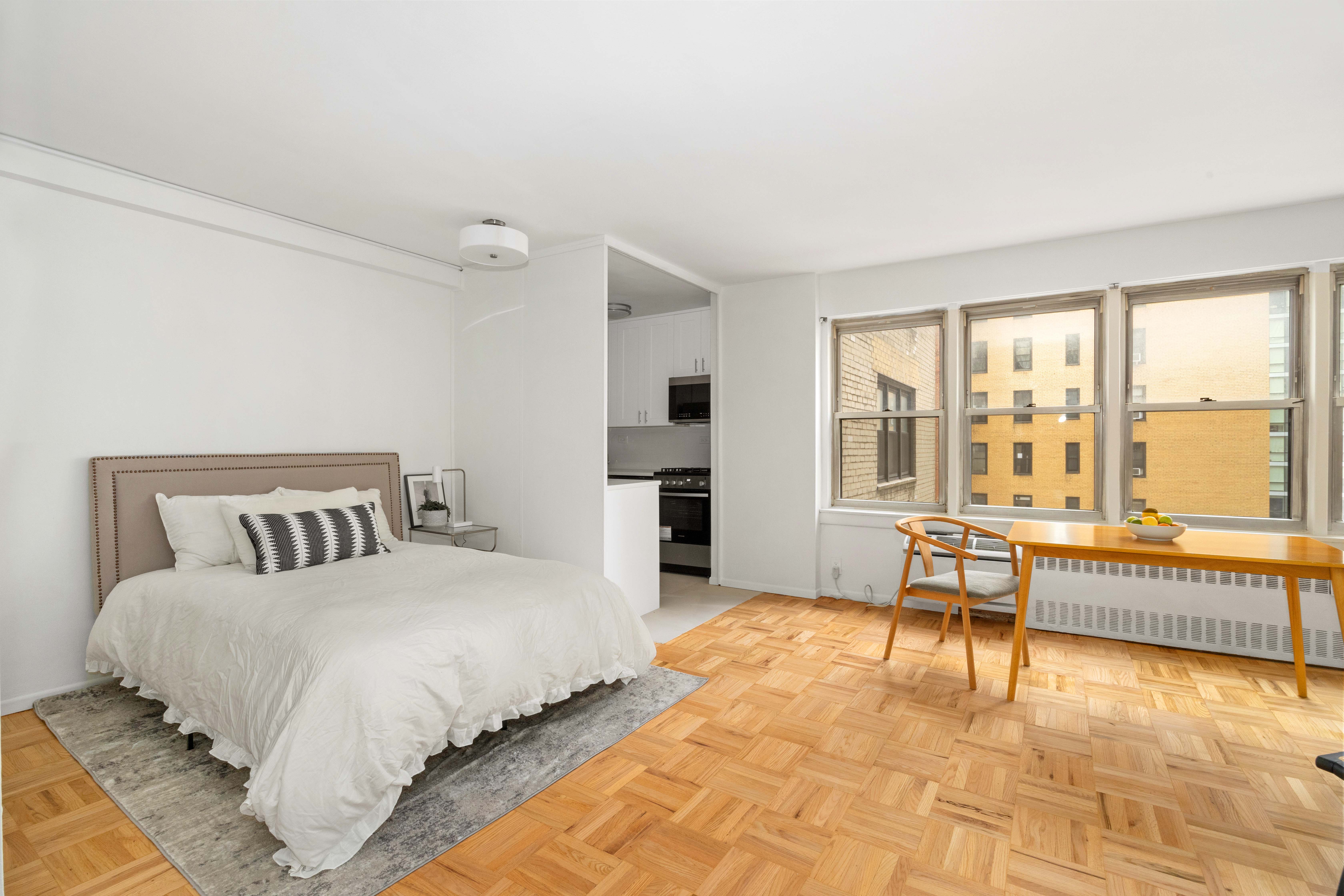 155 East 38th Street, Unit 8A Manhattan, NY 10016 - Photo 4 of 8 a spacious bedroom with a bed and a large window
