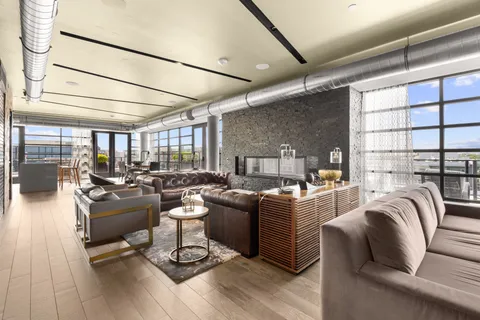 a living room with lots of furniture and hard wood flooring