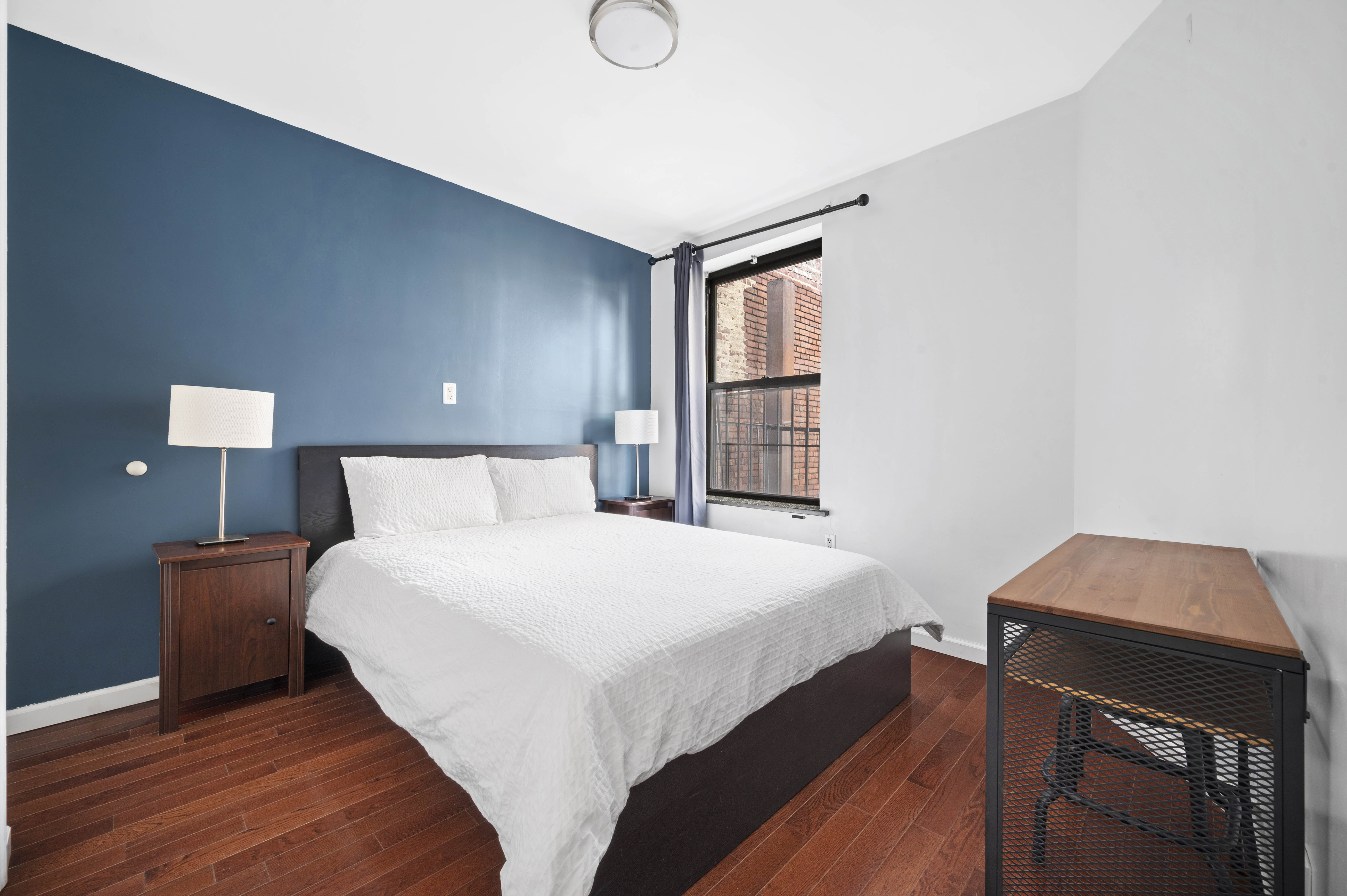 40 East Broadway, Unit 5 Manhattan, NY 10002 - Photo 3 of 10 a bedroom with a bed and a window