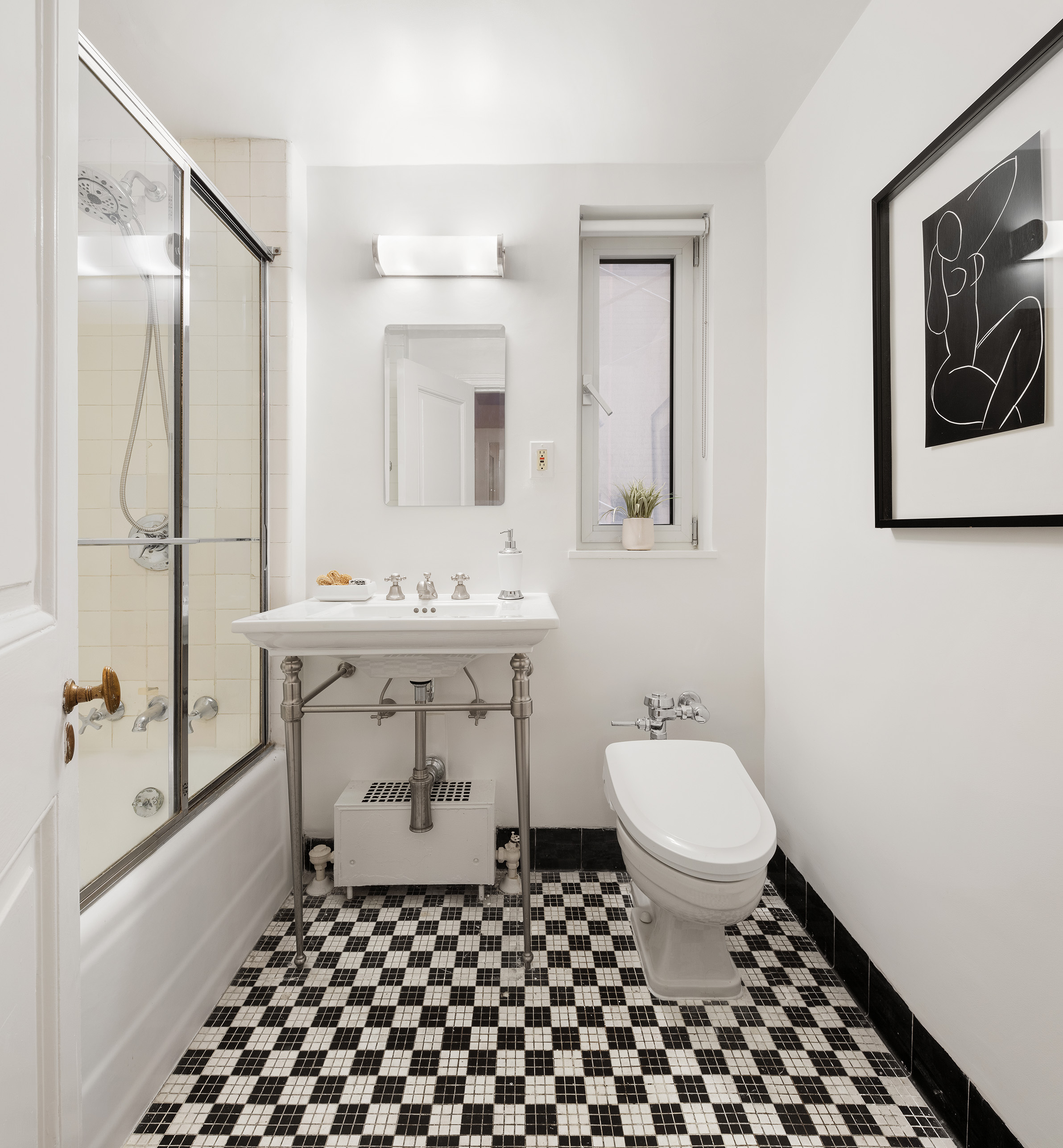 150 Central Park South, Unit 1010 Manhattan, NY 10019 - Photo 7 of 9 a bathroom with a sink toilet and shower