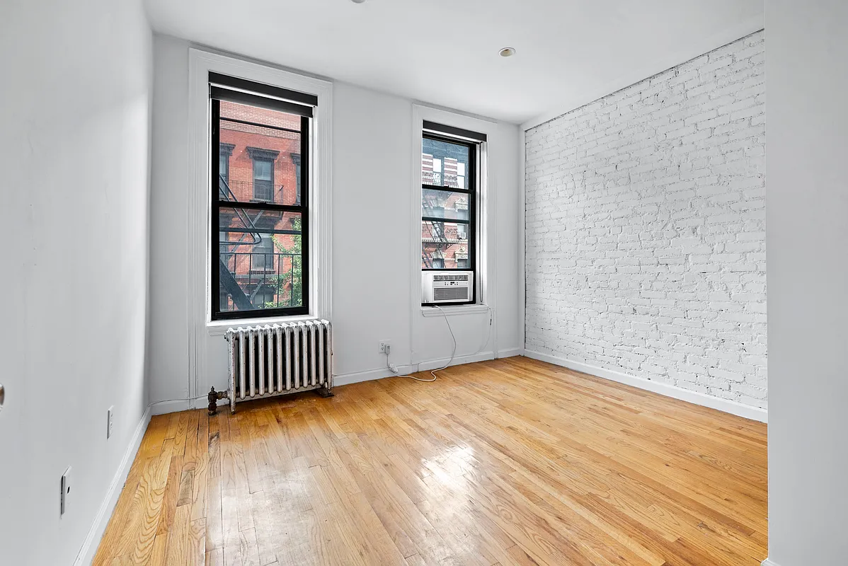 142 Sullivan Street, Unit 19 Manhattan, NY 10012 - Photo 2 of 11 an empty room with windows