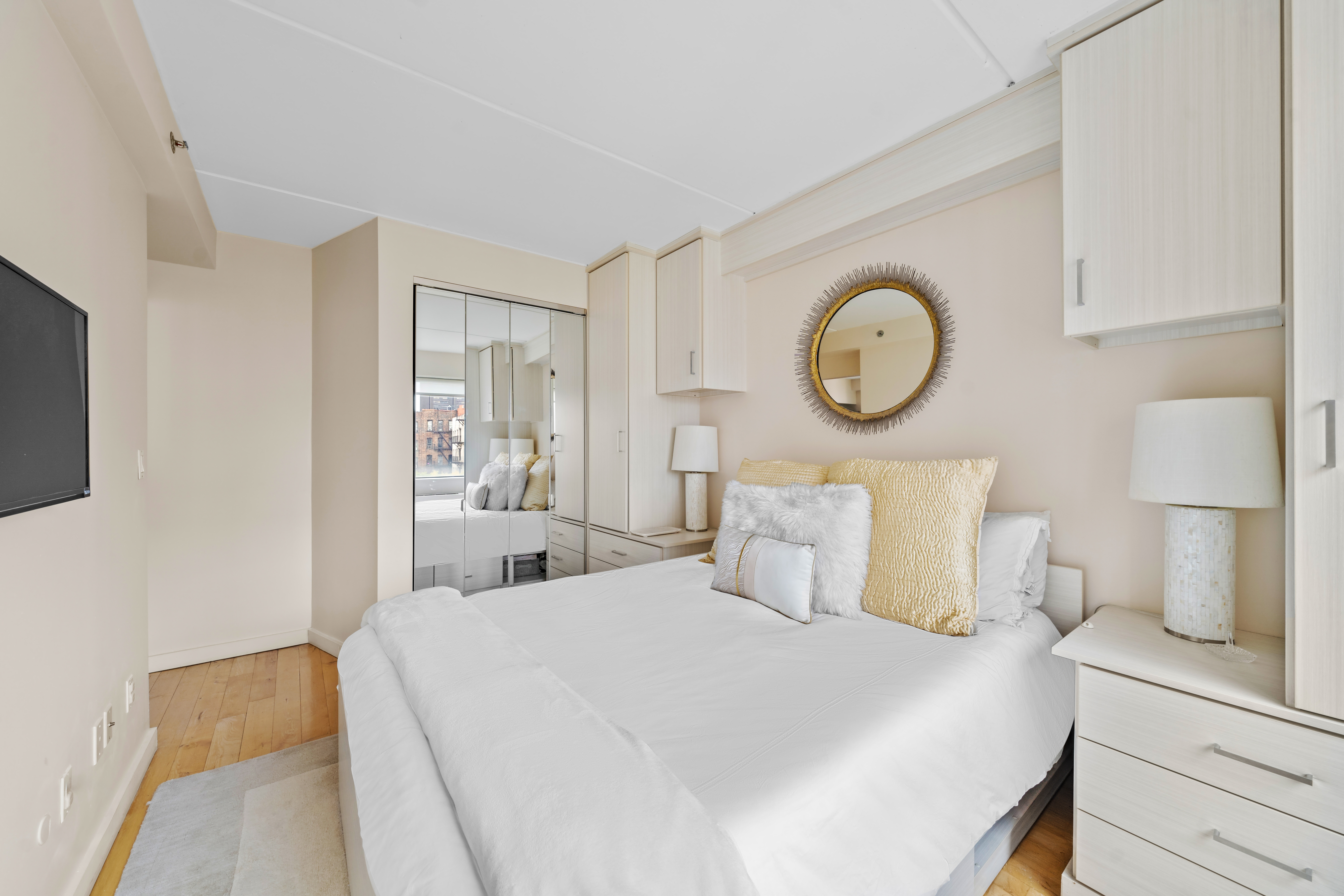 1810 3rd Avenue, Unit A9B Manhattan, NY 10029 - Photo 10 of 16 a bedroom with a bed and a lamp on dresser