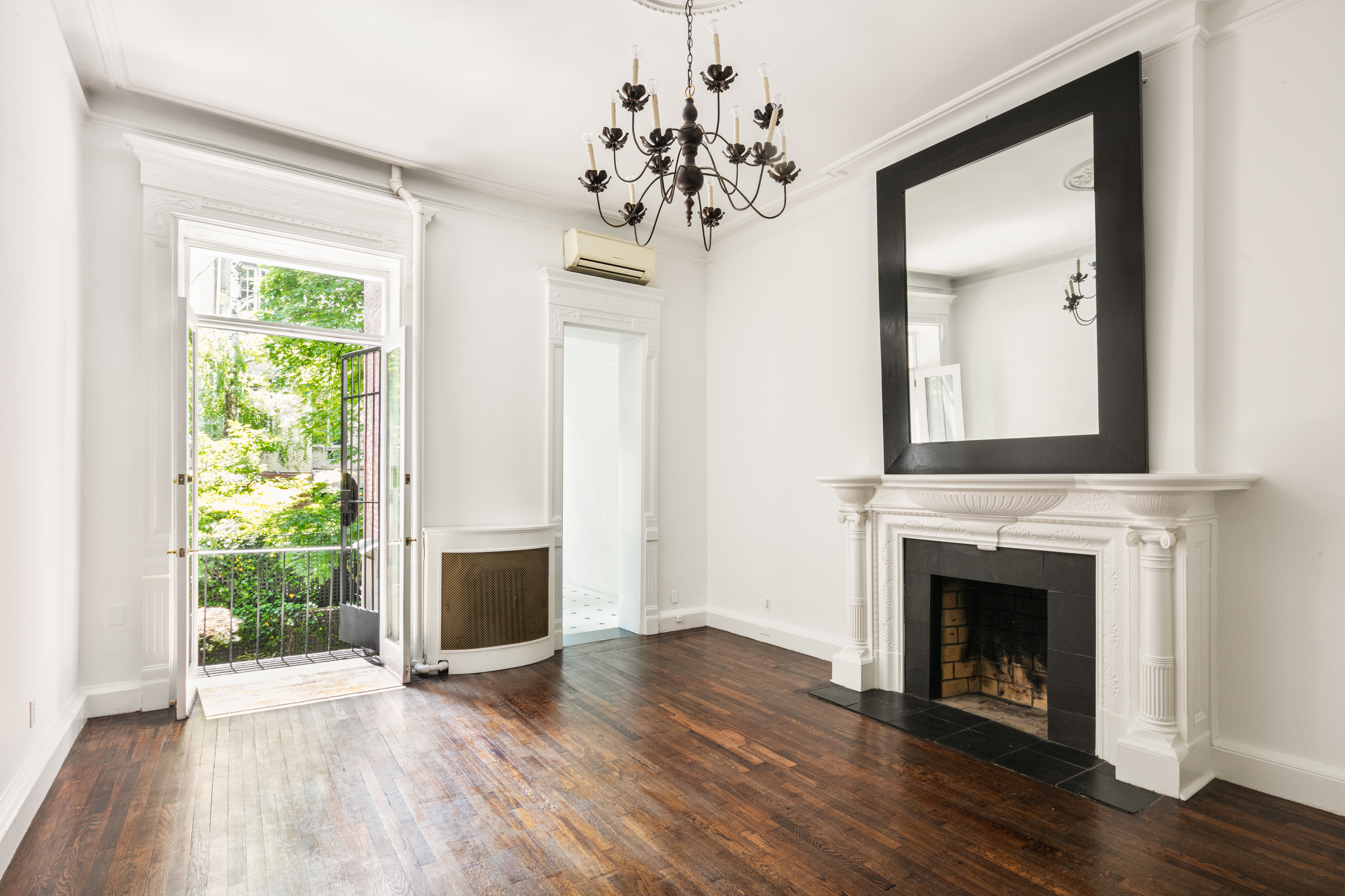 112 West 78th Street, Unit PARLOR Manhattan, NY 10024 - Photo 2 of 37 a view of a livingroom with a fireplace wooden floor and windows