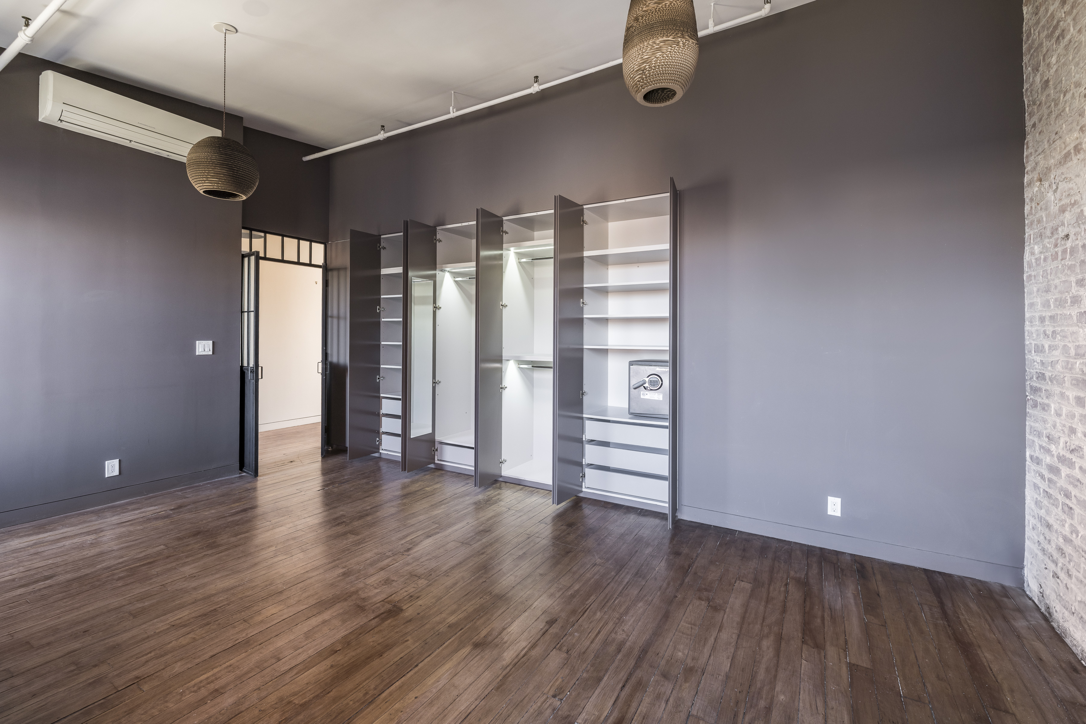 705 Driggs Avenue, Unit 13 Brooklyn, NY 11211 - Photo 9 of 15 a view of an empty room with wooden floor and a window