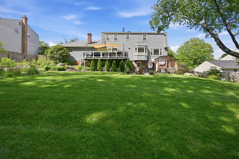 a view of a house with a tree in the background