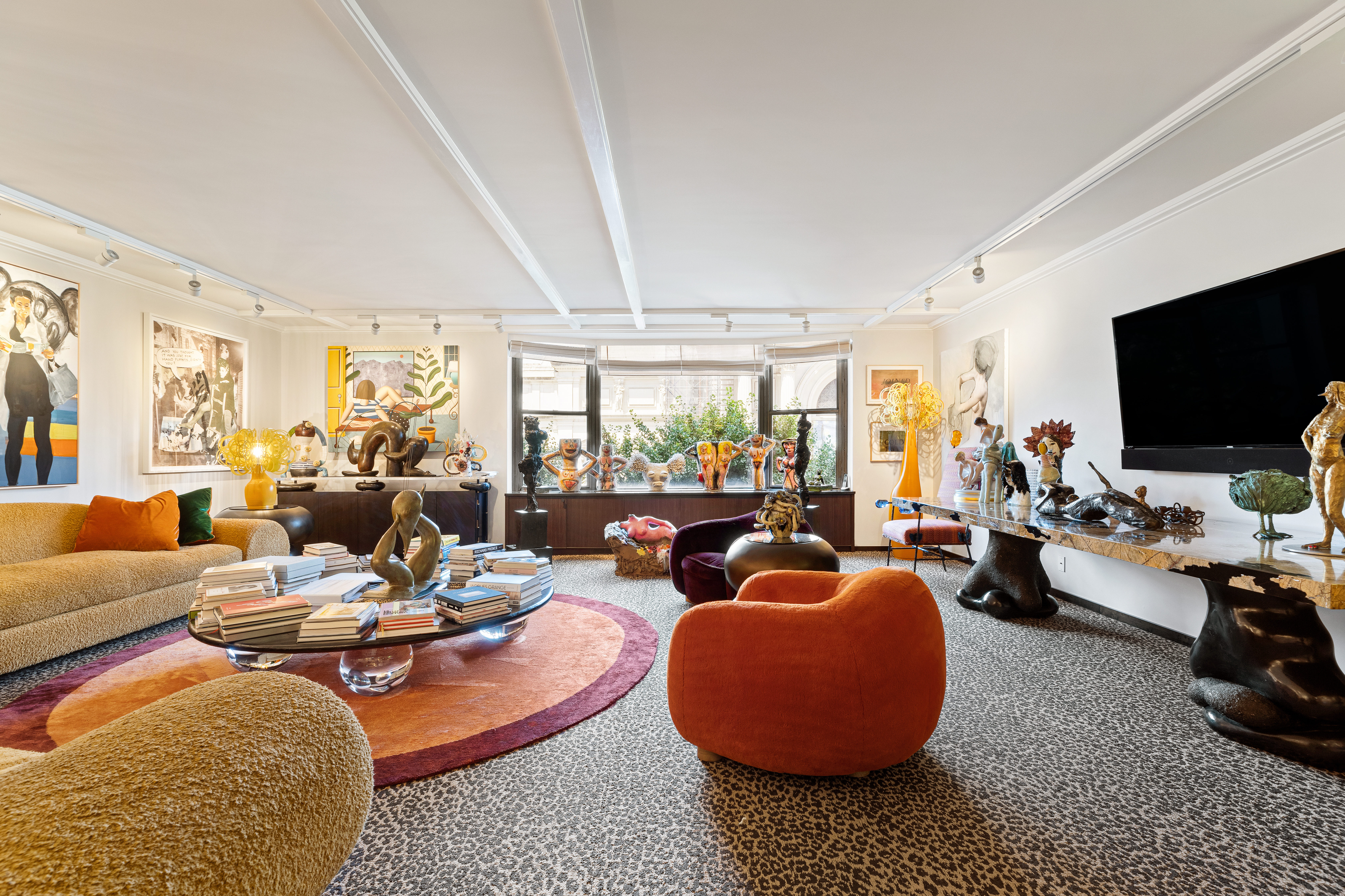 1001 5th Avenue, Unit 4C Manhattan, NY 10028 - Photo 3 of 11 a living room with furniture a rug and a flat screen tv