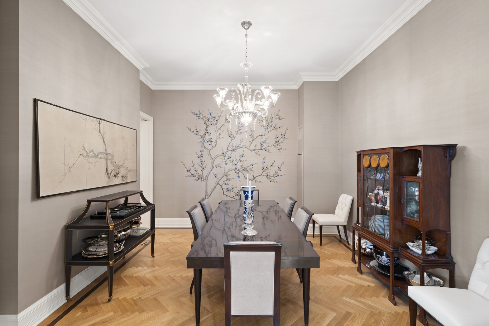 1 Central Park South, Unit 915 Manhattan, NY 10019 - Photo 19 of 29 a view of a dining room with furniture and chandelier