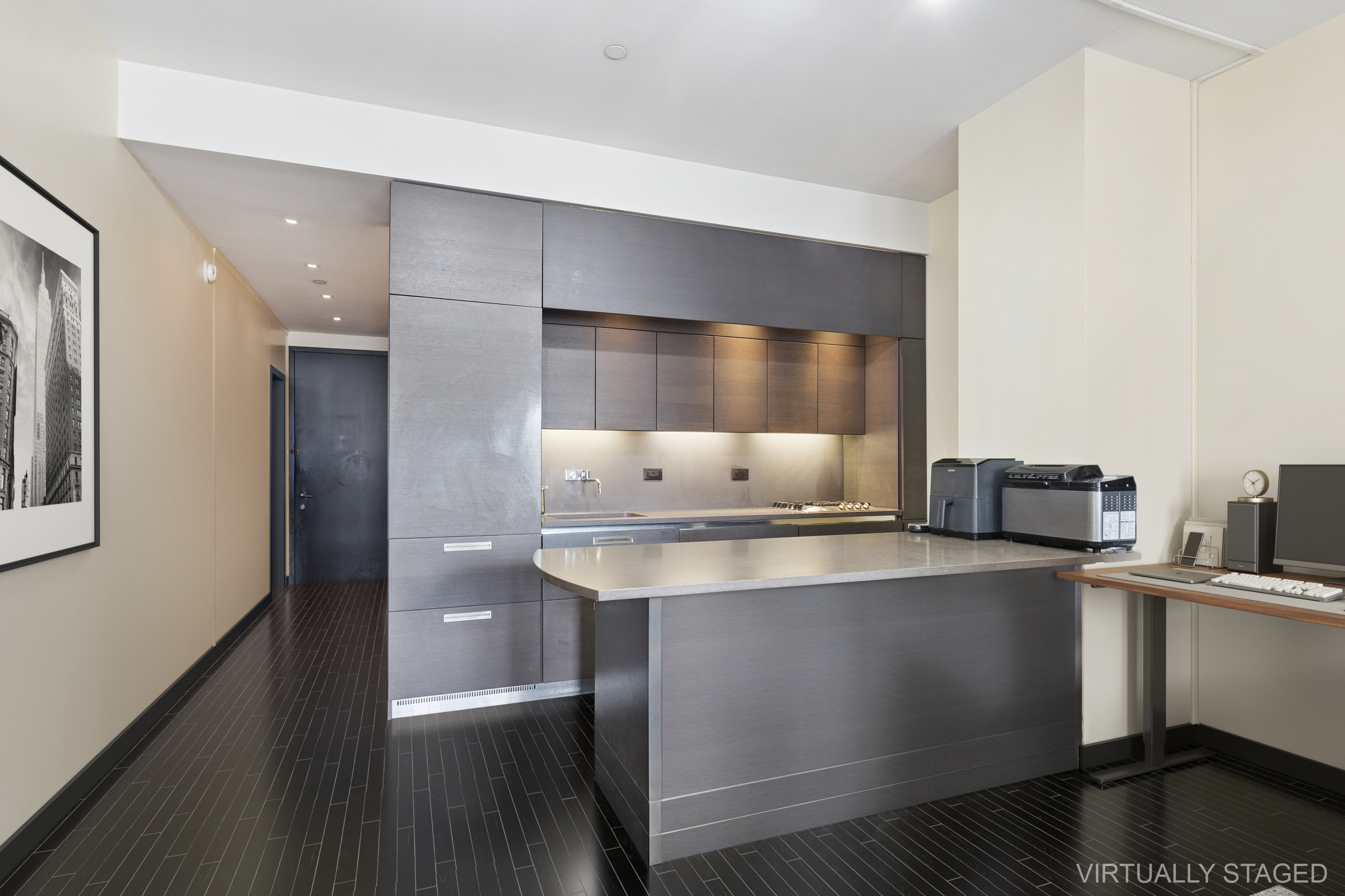 20 Pine Street, Unit 2401 Manhattan, NY 10005 - Photo 2 of 11 a kitchen with stainless steel appliances a sink and cabinets