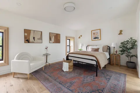 a bedroom with a bed and a couch