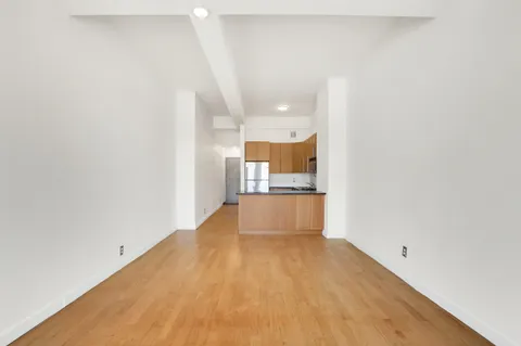 a view of a kitchen with a sink and a refrigerator
