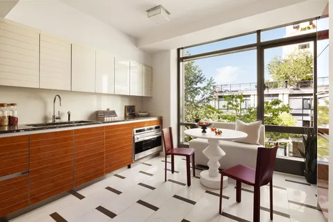 a kitchen with stainless steel appliances granite countertop sink microwave dining table and chairs