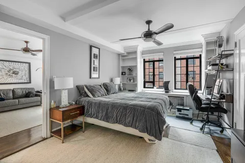 a spacious bedroom with a bed and a table