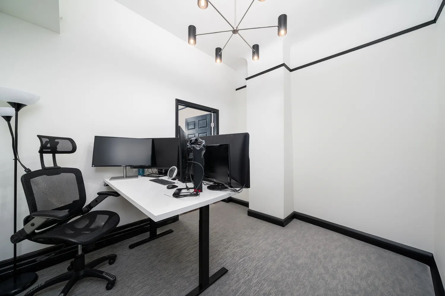 a view of a workspace with furniture and a window