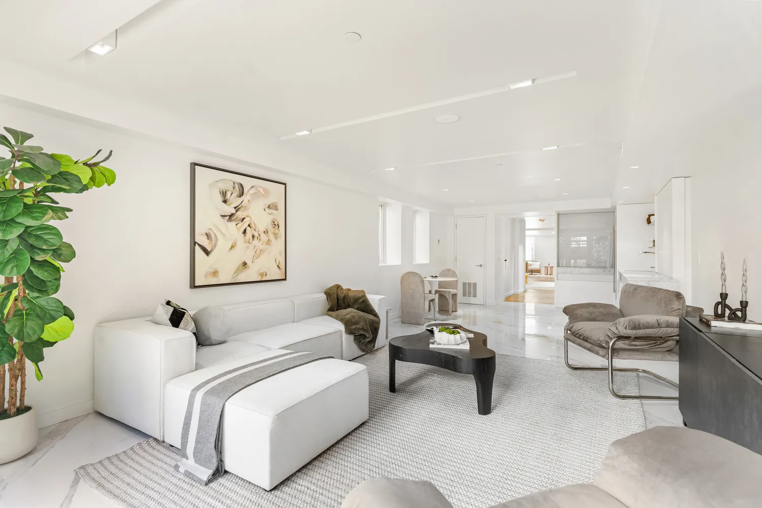 a living room with furniture and a potted plant