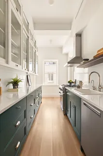 a large kitchen with stainless steel appliances lots of counter space and a sink