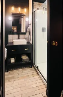 a bathroom with a shower toilet and sink
