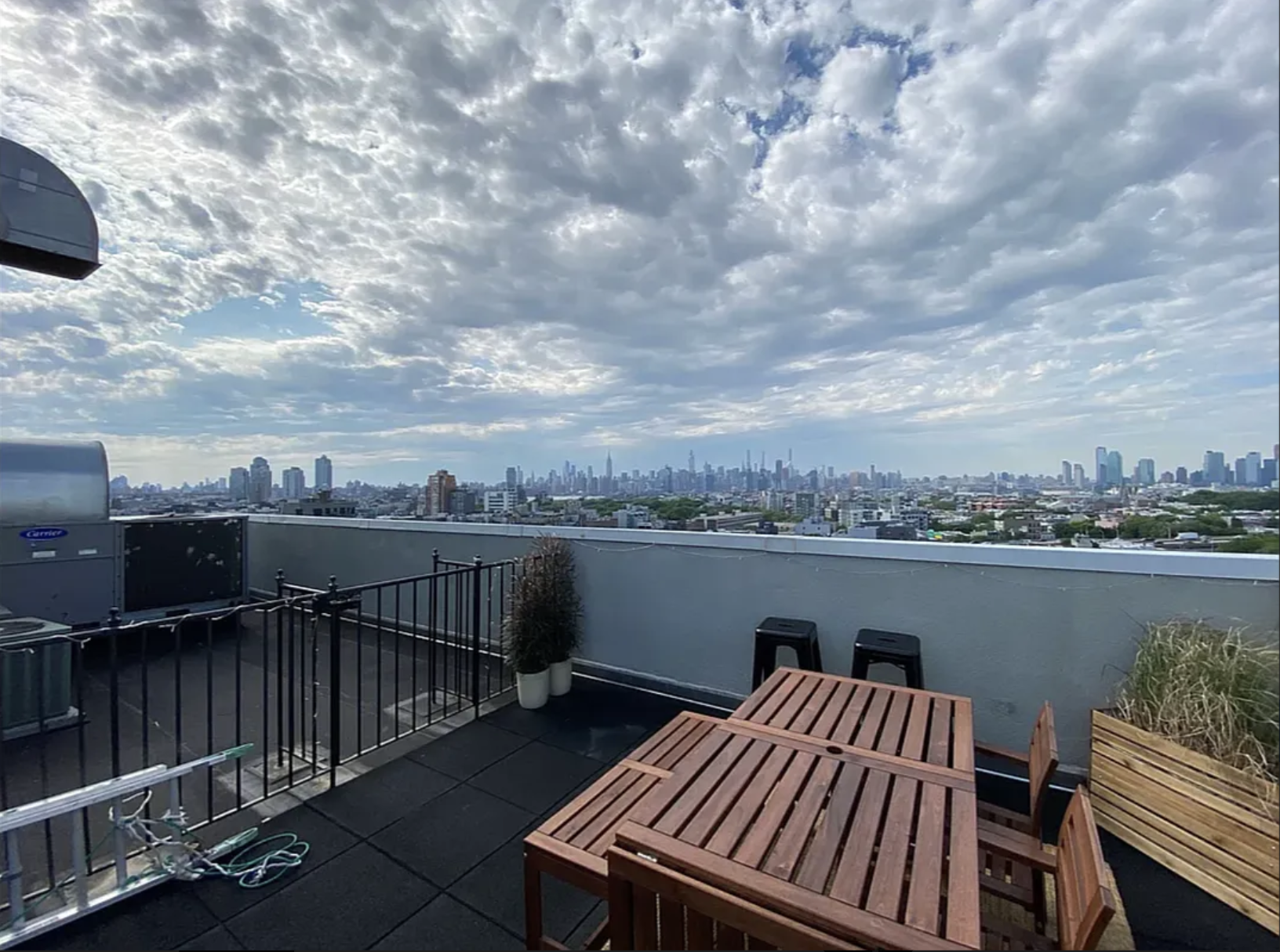 139 Skillman Avenue, Unit 9AB Brooklyn, NY 11211 - Photo 13 of 19 a view of a roof deck with table and chairs